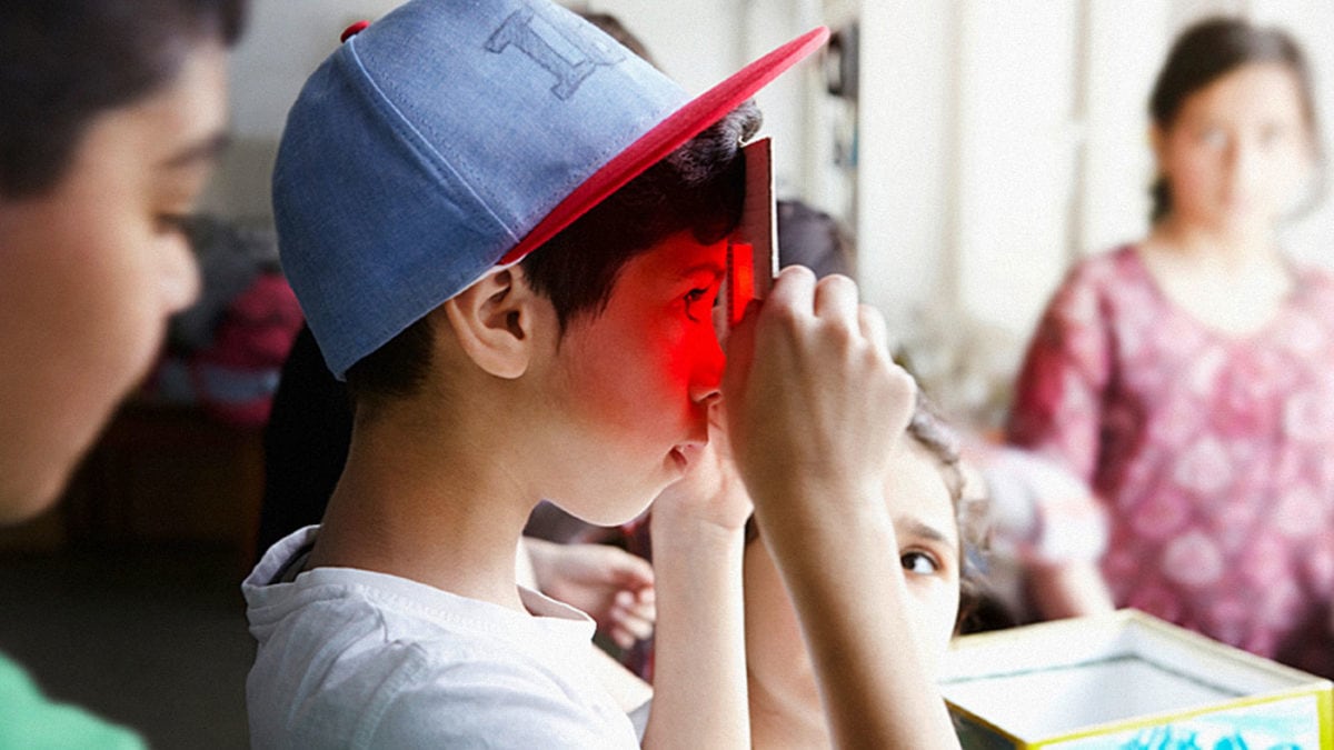Kreativ Kindergeburtstag in Berlin feiern: Junge schaut durch rote Scheibe im Museum // HIMBEER